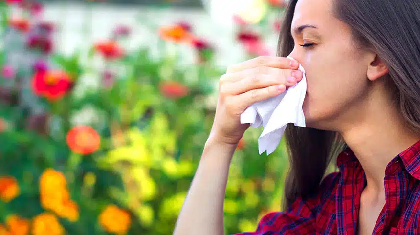 Woman Holding Tissue on Her nose Due to Pollen allergies
