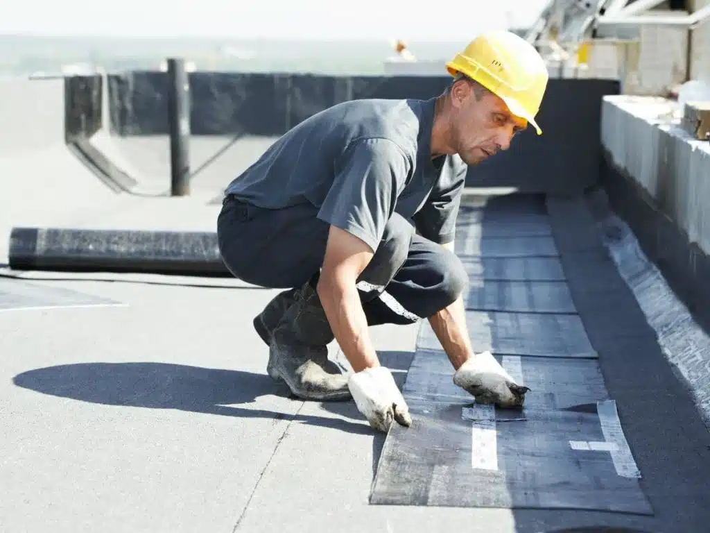 man installing a flat roof
