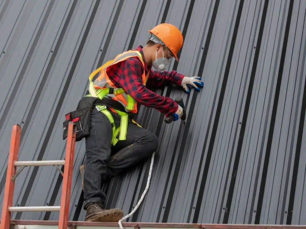 roofer installing metal sheet
