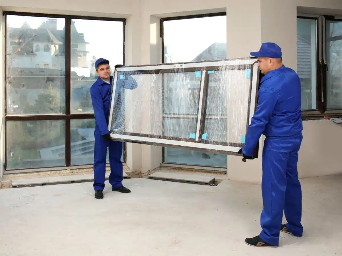 Man in red polo inspecting roof